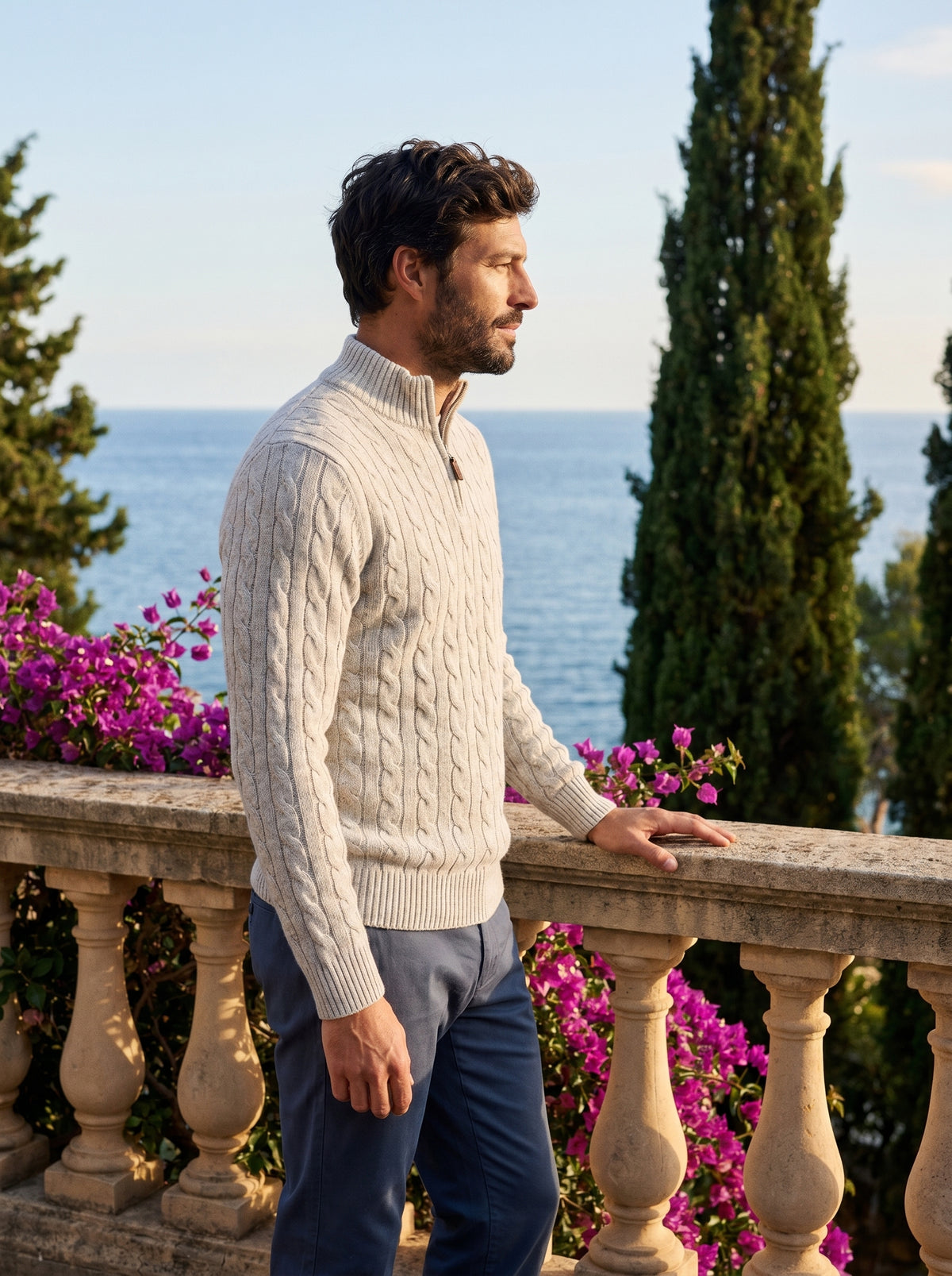Side profile of a man wearing a cable knit wool half-zip jumper overlooking Lake Como — Belvoirne