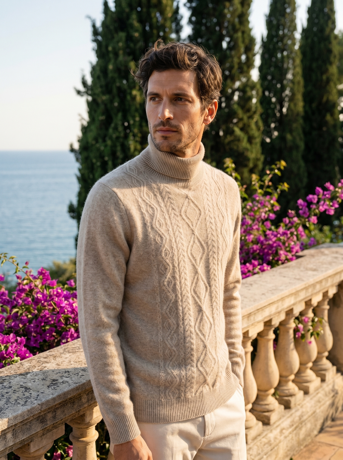 Man wearing a beige cable knit wool roll neck jumper on a balcony overlooking Lake Como, old money style — Belvoirne