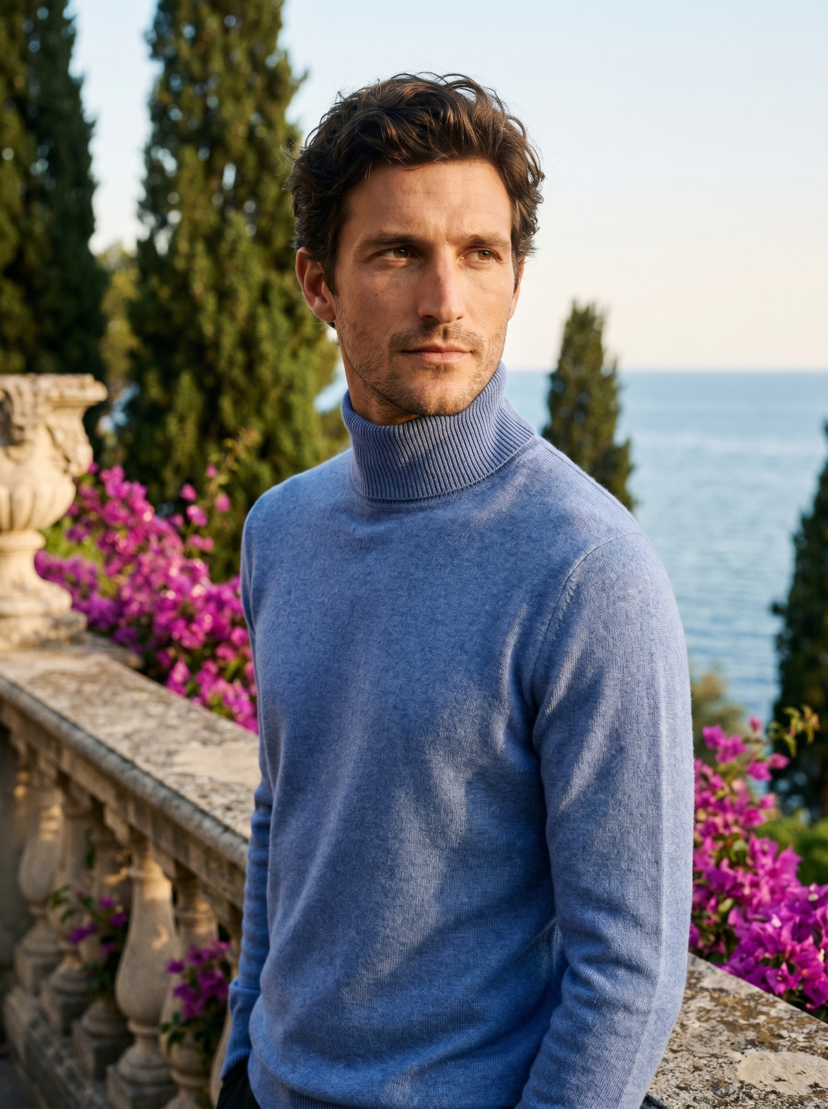 Man wearing a blue pure wool roll neck jumper on a balcony overlooking Lake Como, old money style — Belvoirne