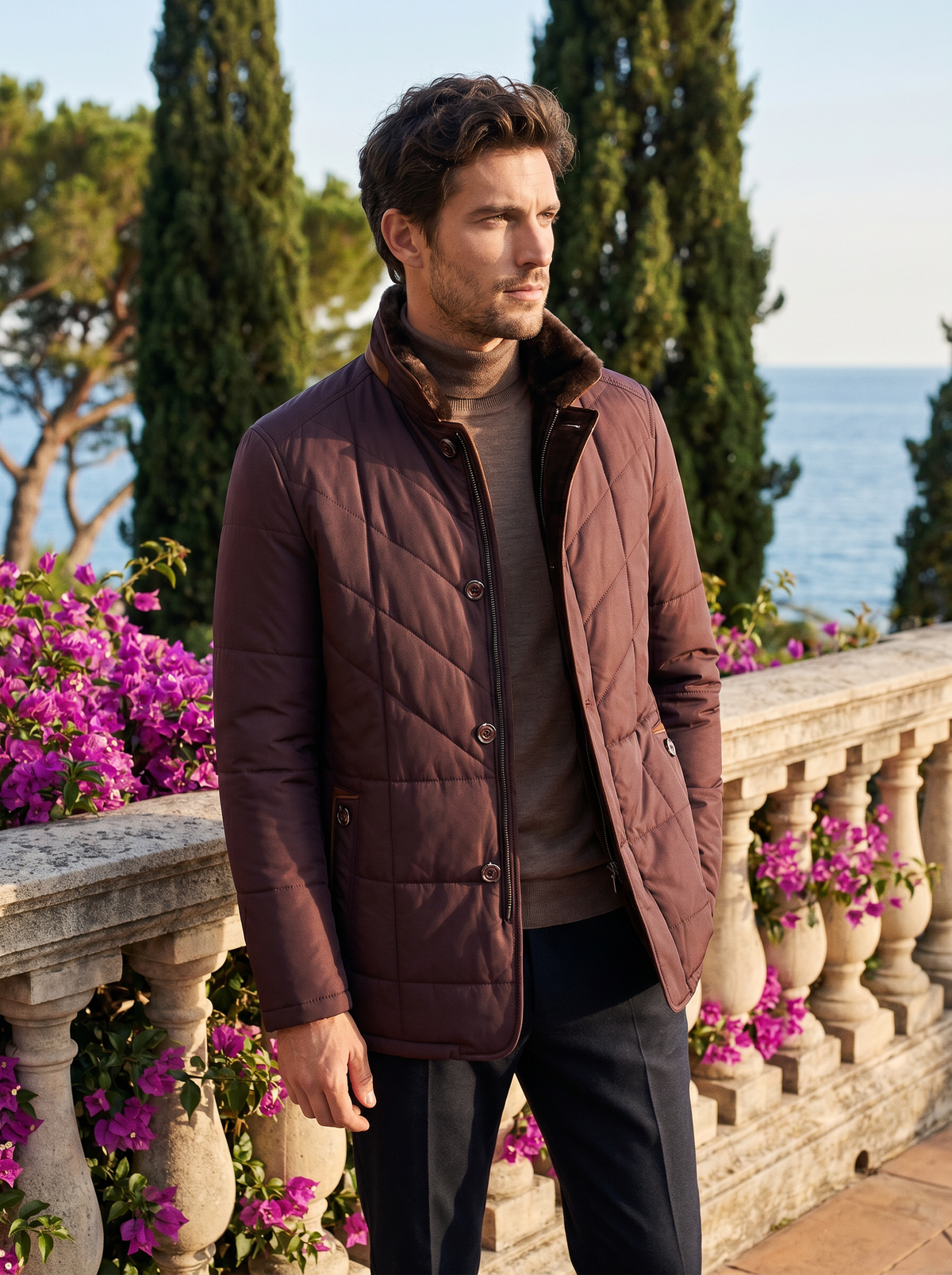 Man wearing a deep burgundy quilted jacket on a balcony overlooking Lake Como, old money style — Belvoirne