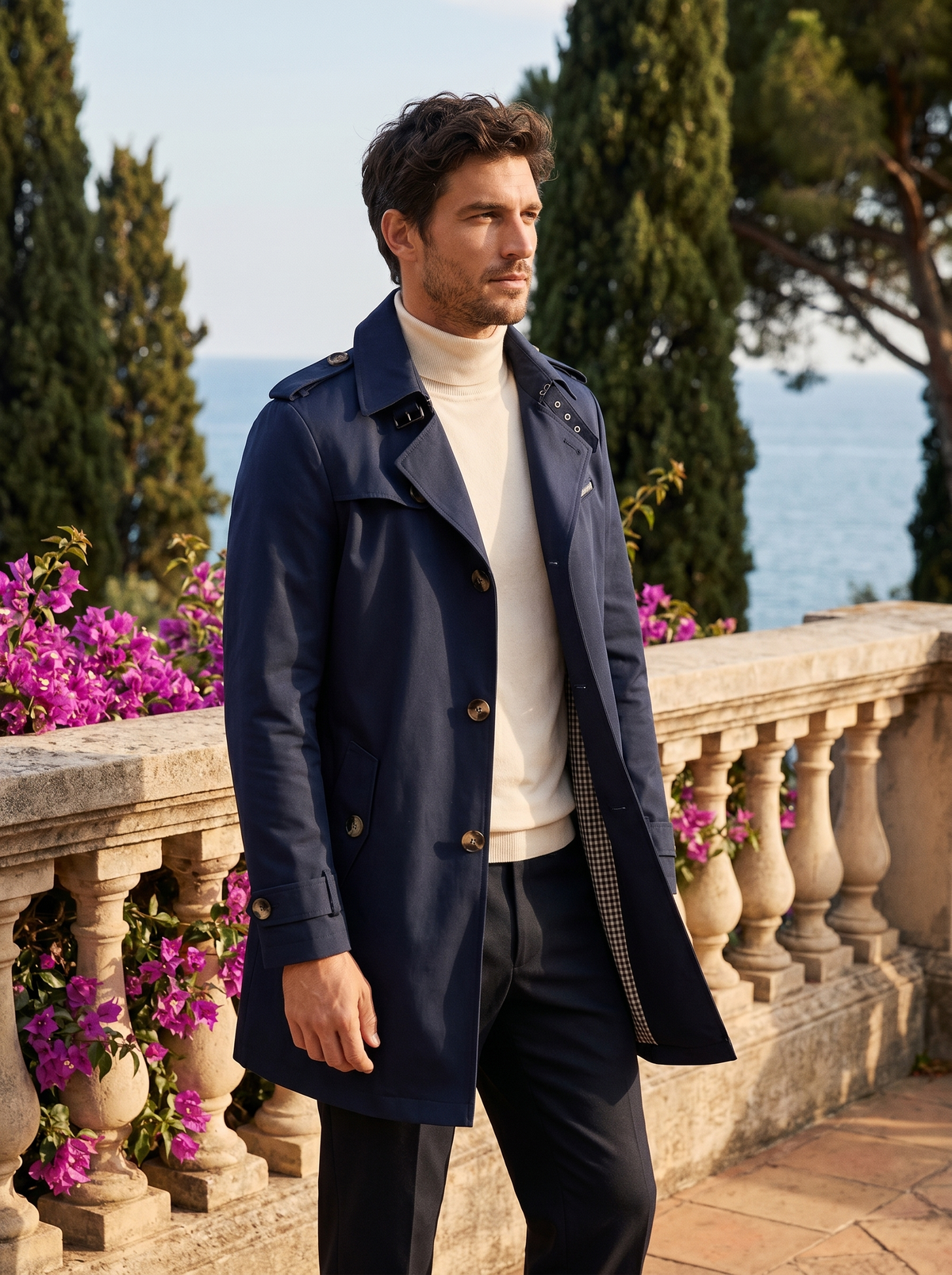 Man wearing a navy cotton trench coat on a balcony overlooking Lake Como, old money style — Belvoirne