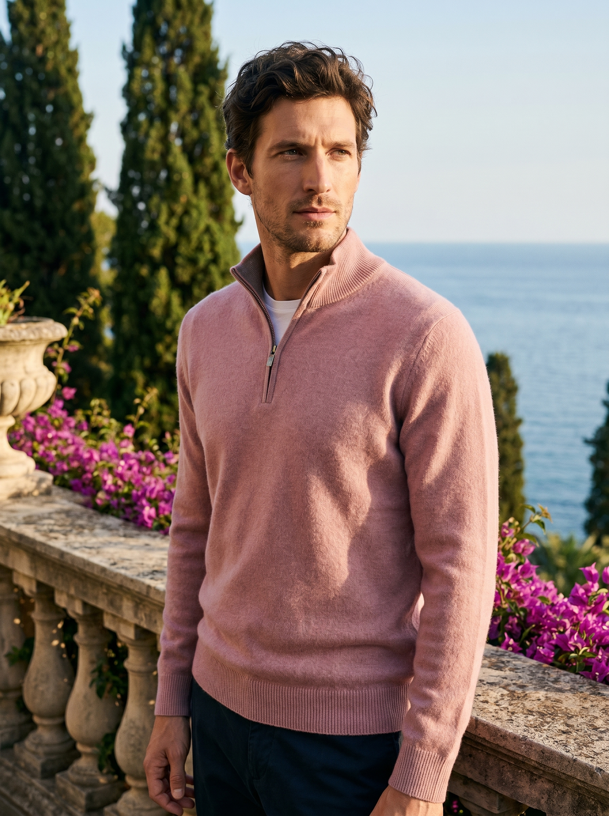 Man wearing a pink wool half-zip jumper on a balcony overlooking Lake Como, old money style — Belvoirne