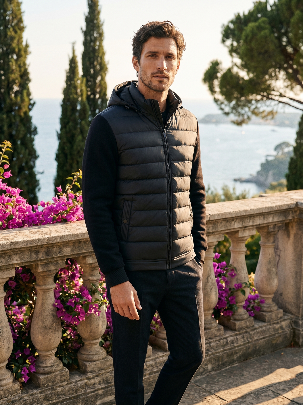 Full-length shot of a man in a hooded puffer jacket by Lake Como — Belvoirne