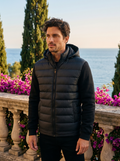 Man wearing a hooded puffer jacket on a Lake Como terrace, old money style — Belvoirne