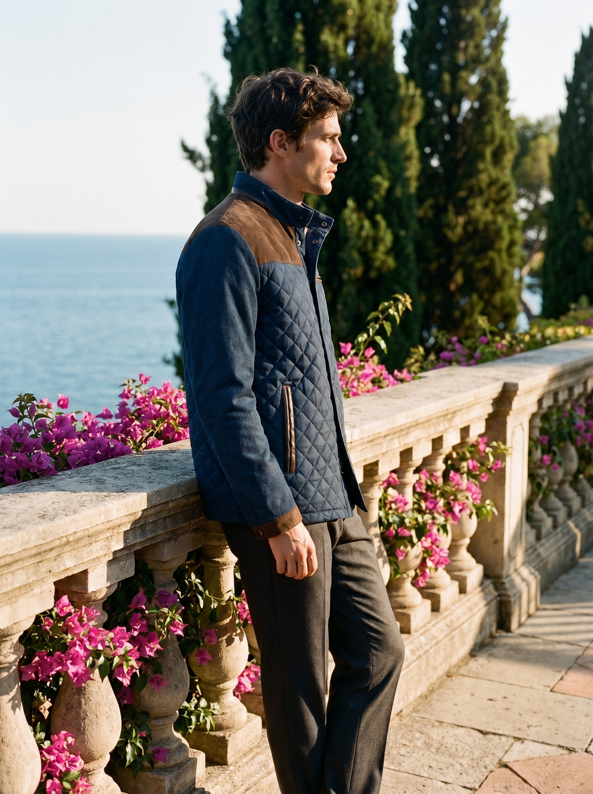 Side profile of a man wearing a quilted jacket overlooking Lake Como — Belvoirne
