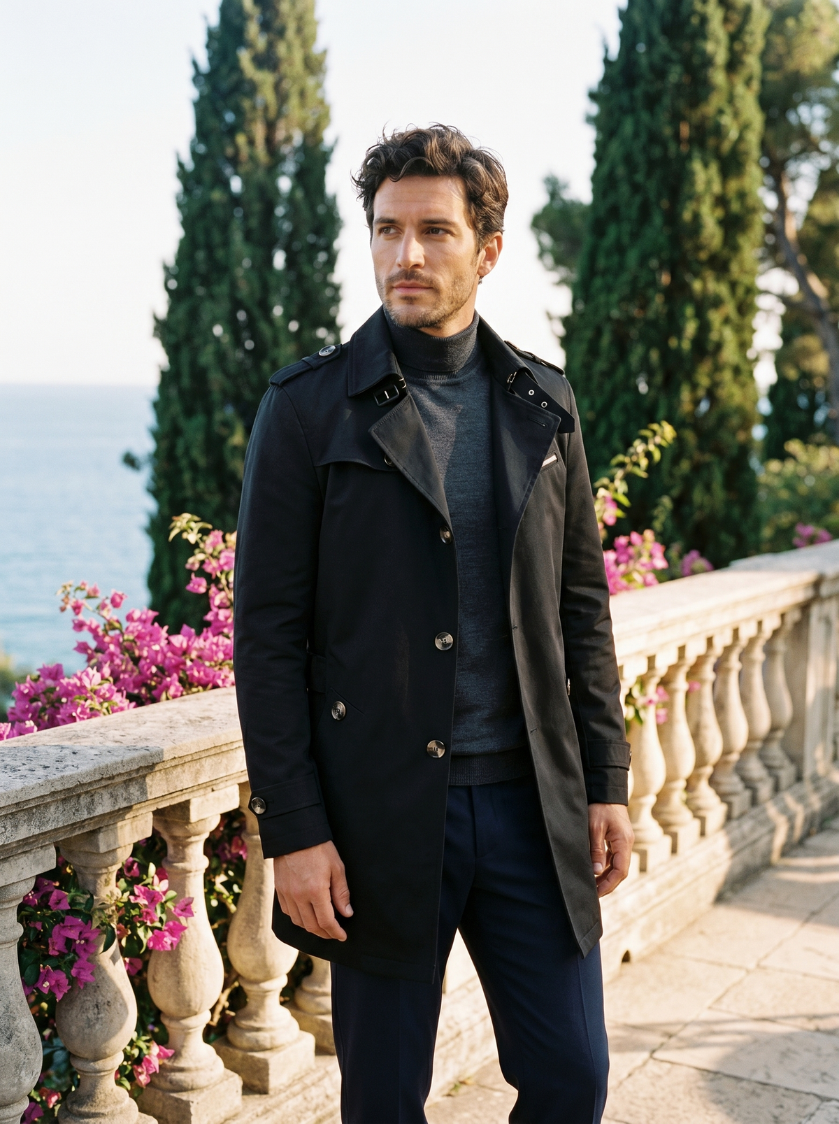 Man wearing a black cotton trench coat on a balcony overlooking Lake Como, old money style — Belvoirne