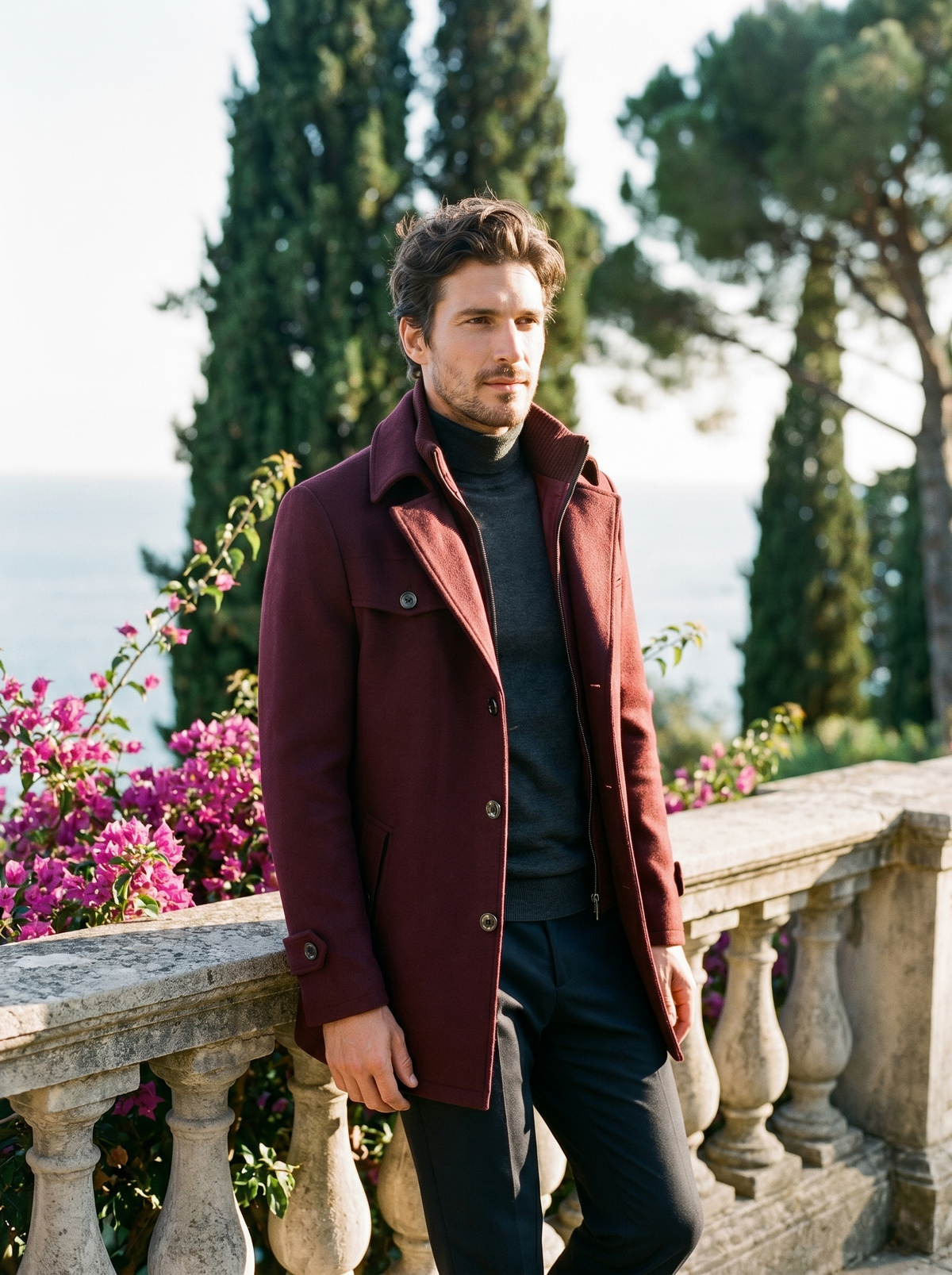 Man wearing a burgundy wool double-collar coat on a balcony overlooking Lake Como, old money style — Belvoirne