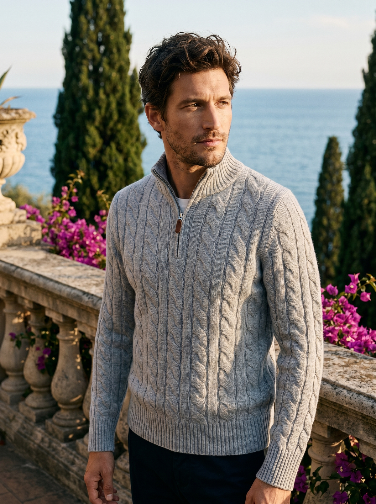 Man wearing a light grey cable knit wool half-zip jumper on a balcony overlooking Lake Como, old money style — Belvoirne
