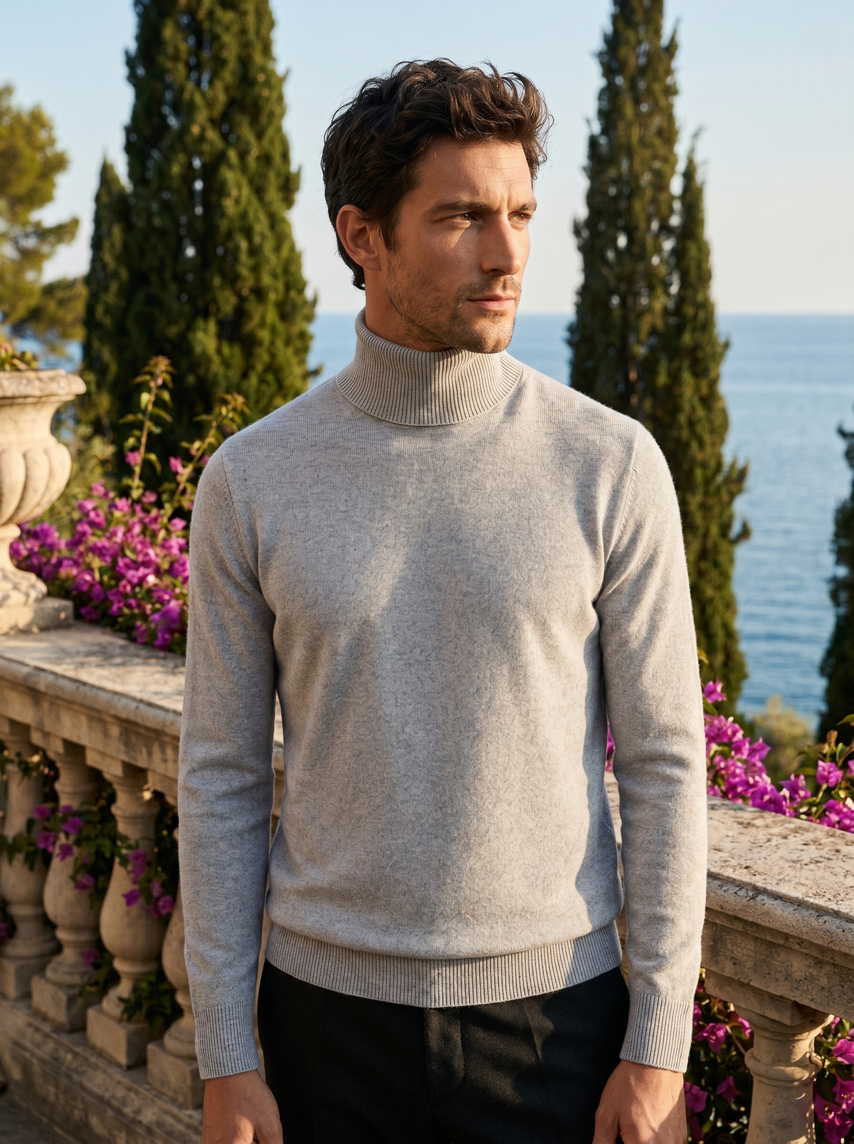 Man wearing a light grey pure wool roll neck jumper on a balcony overlooking Lake Como, old money style — Belvoirne